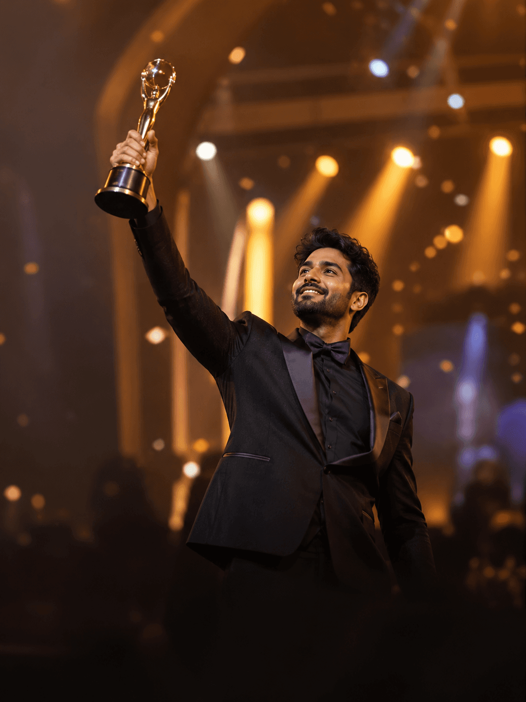 A creator raising a trophy on stage